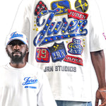 A man modeling a white graphic T-shirt, showing both the front and back views. The back features a large, colorful patchwork-style graphic with the word 'Juren' in blue script, red banners, and blue stars.