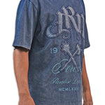Person wearing a blue acid wash  t-shirt with graphic design and text JRN Battle Axe Logo with the words Forever Paradise Dreams.