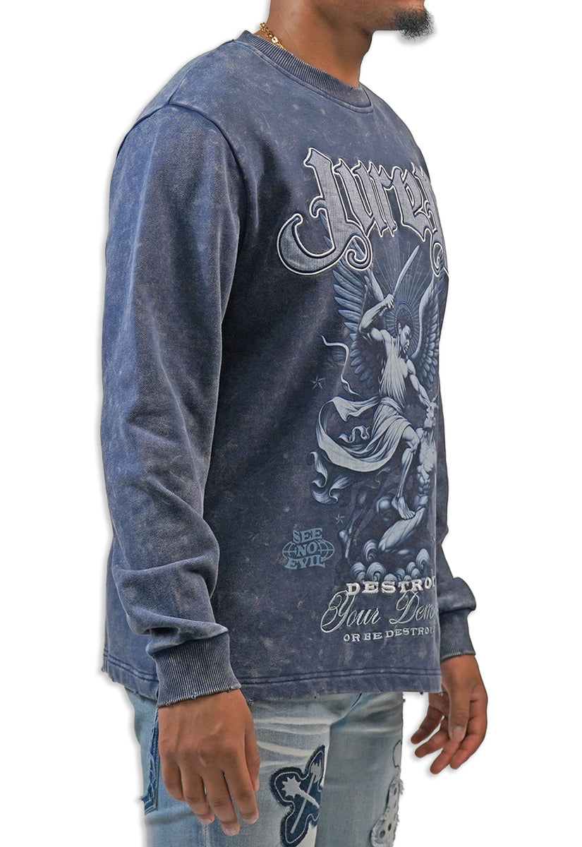 Man wearing a blue acid wash long-sleeve graphic t-shirt with a design on the back against a white background