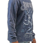 Man wearing a blue acid wash long-sleeve graphic t-shirt with a design on the back against a white background