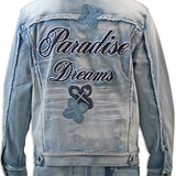 Light blue denim jacket with 'Paradise Dreams' text and butterfly designs on a white background