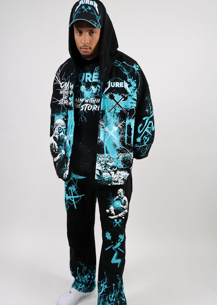 Person wearing a black and teal graphic hoodie and pants set on a white & teal background