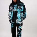Person wearing a black and teal graphic hoodie and pants set on a white & teal background