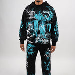 Person wearing a black and teal graphic hoodie and pants set on a white background