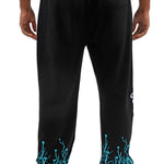 Black pants with teal designs on the cuffs worn by a person on a white background