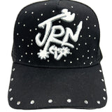 Black cap with white embellishments and 'JRN' logo on a white background